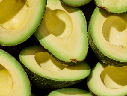 Detail photograph of avocados cut in half.