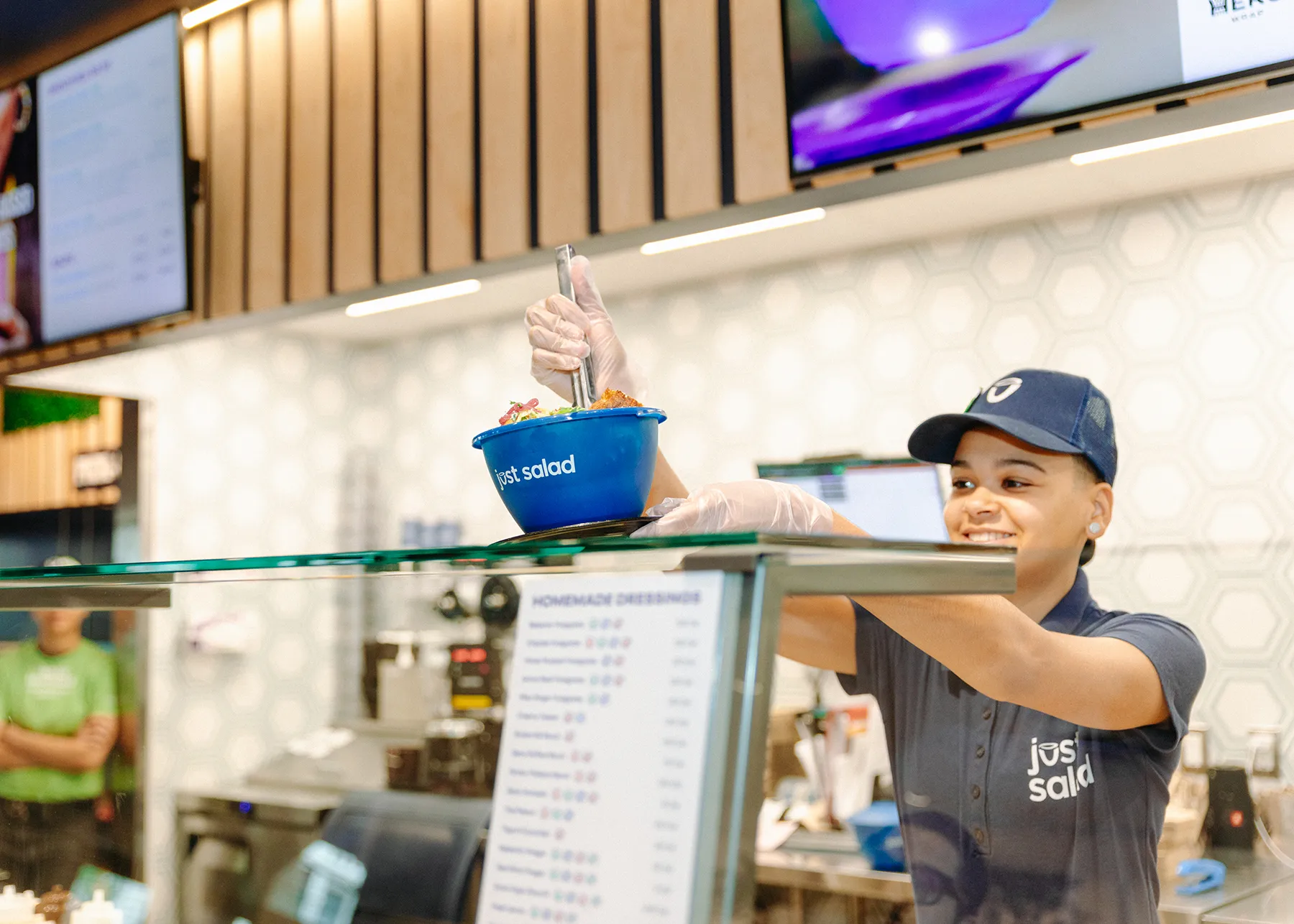 A Just Salad team member preparing a MyBowl salad